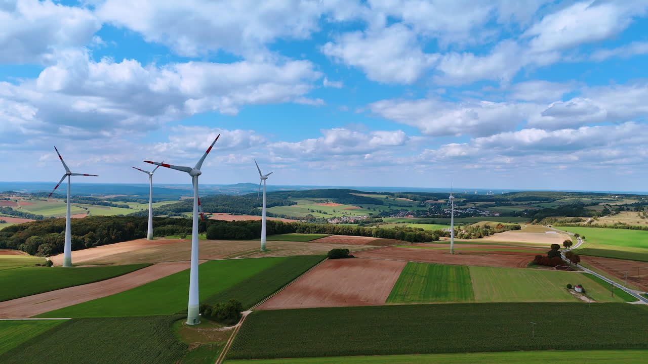 Wind farms produce green energy in the countryside. Sustainable energy concept. Aerial view