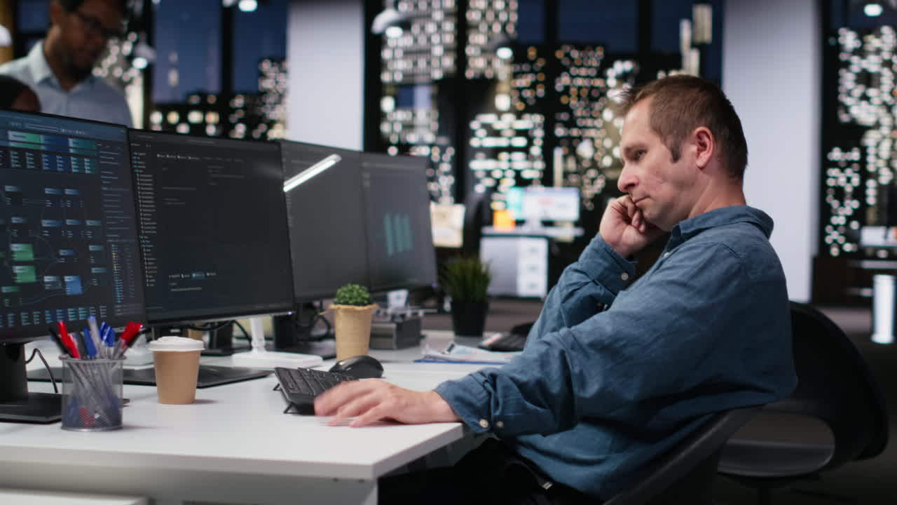 Focused Programmer Working Late Night in Modern Office