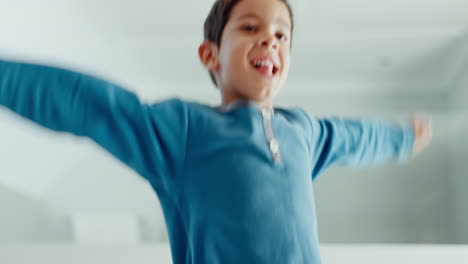 Child,-boy-and-happy-jumping-in-bedroom