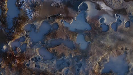 smoke rising from hot mud pots in reykjanes peninsula in iceland