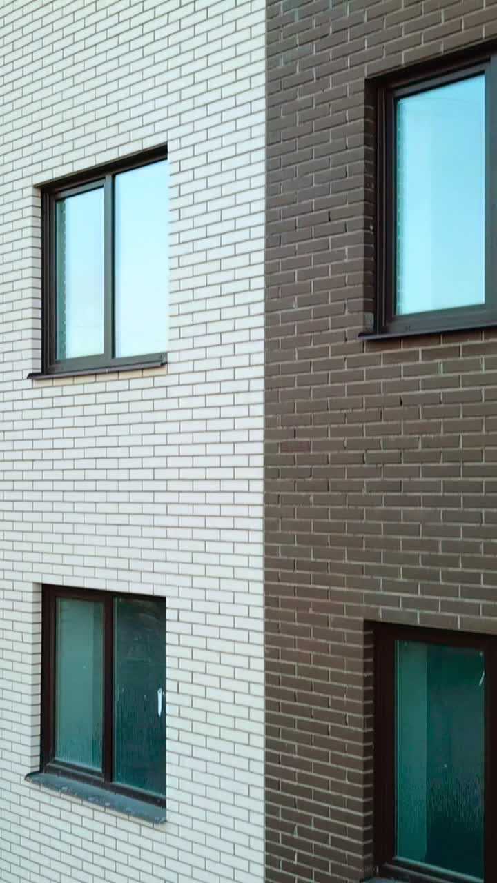 Construction of modern building. Aerial view of high construction building Vertical video