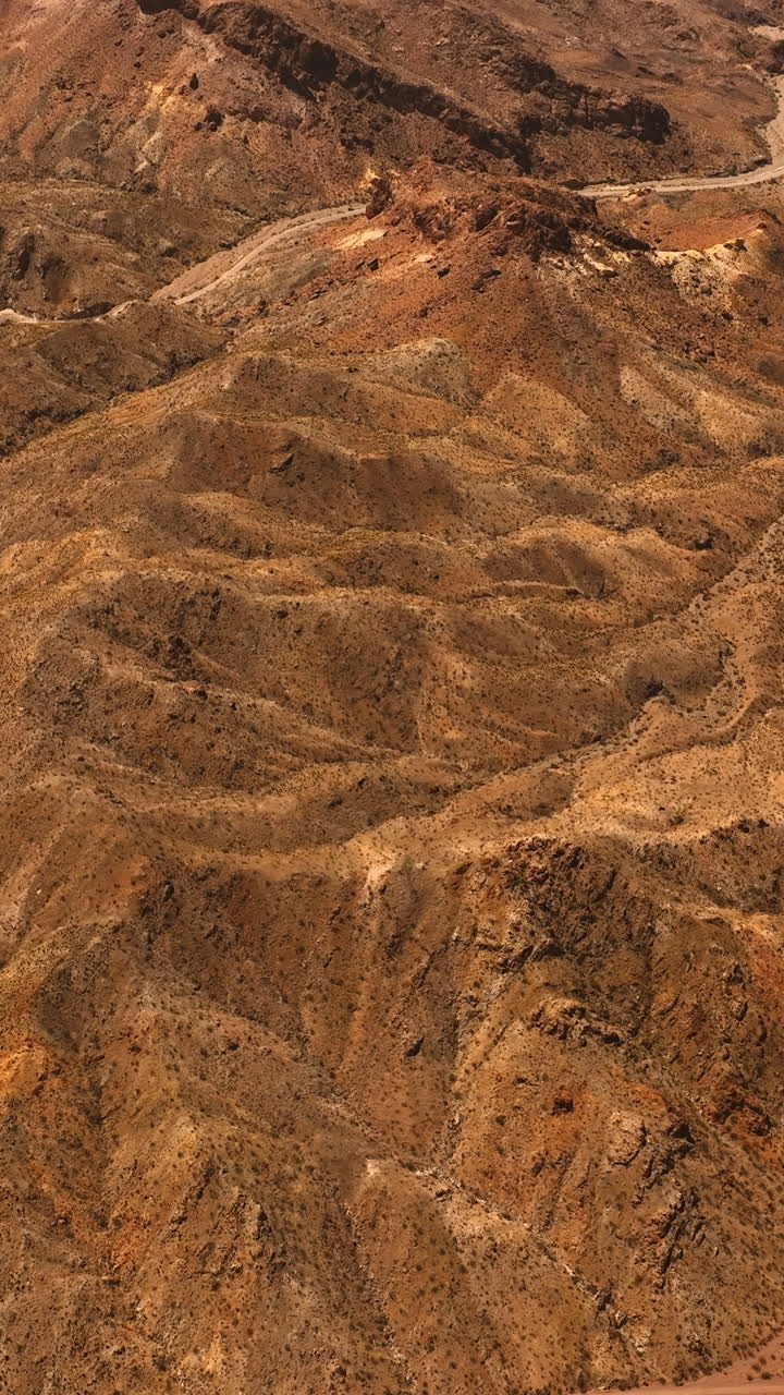 Lifeless deserted rocky landscape with no vegetation. Drone footage above the Mojave desert at daytime. Vertical video
