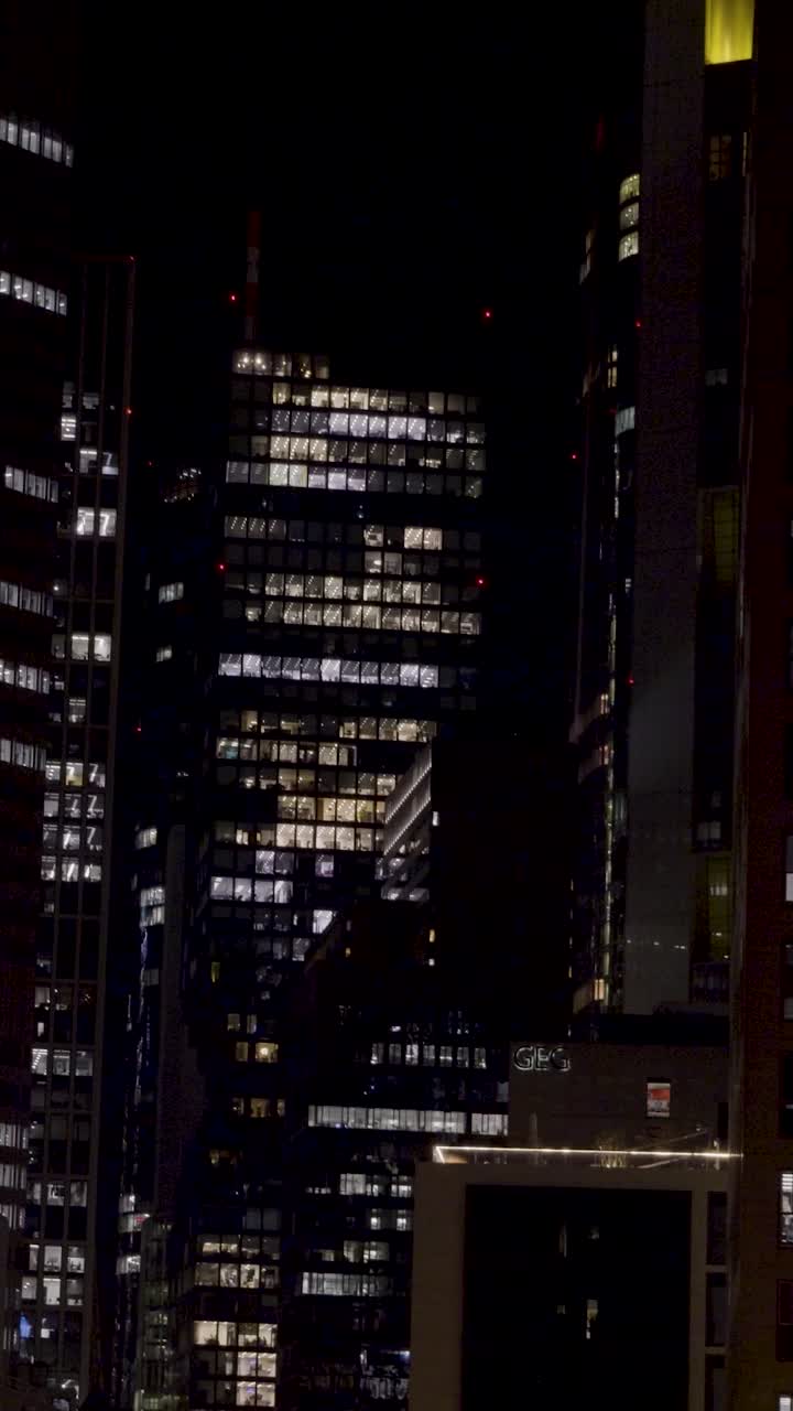 Frankfurt's skyscrapers illuminated at night, urban atmosphere