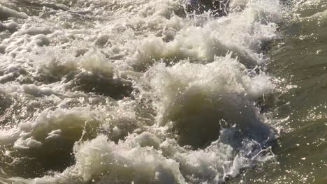 Close-up-view-of-powerful-river-water-crashing-down-a-weir-waterfall