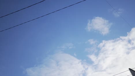 cloudy blue sky with power lines