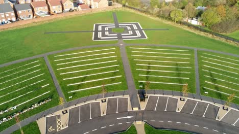 aerial rotating tilt up view above landscaped cemetery garden and target shaped footpath