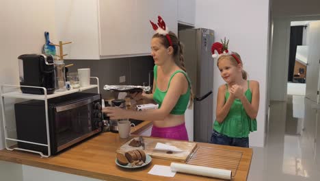 mother and daughter baking christmas cookies