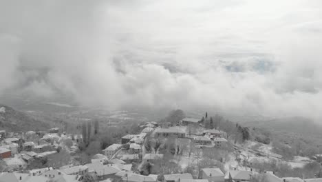 Aerial-footage-over-snowy-mountain,-traditional-village-in-Greece-5