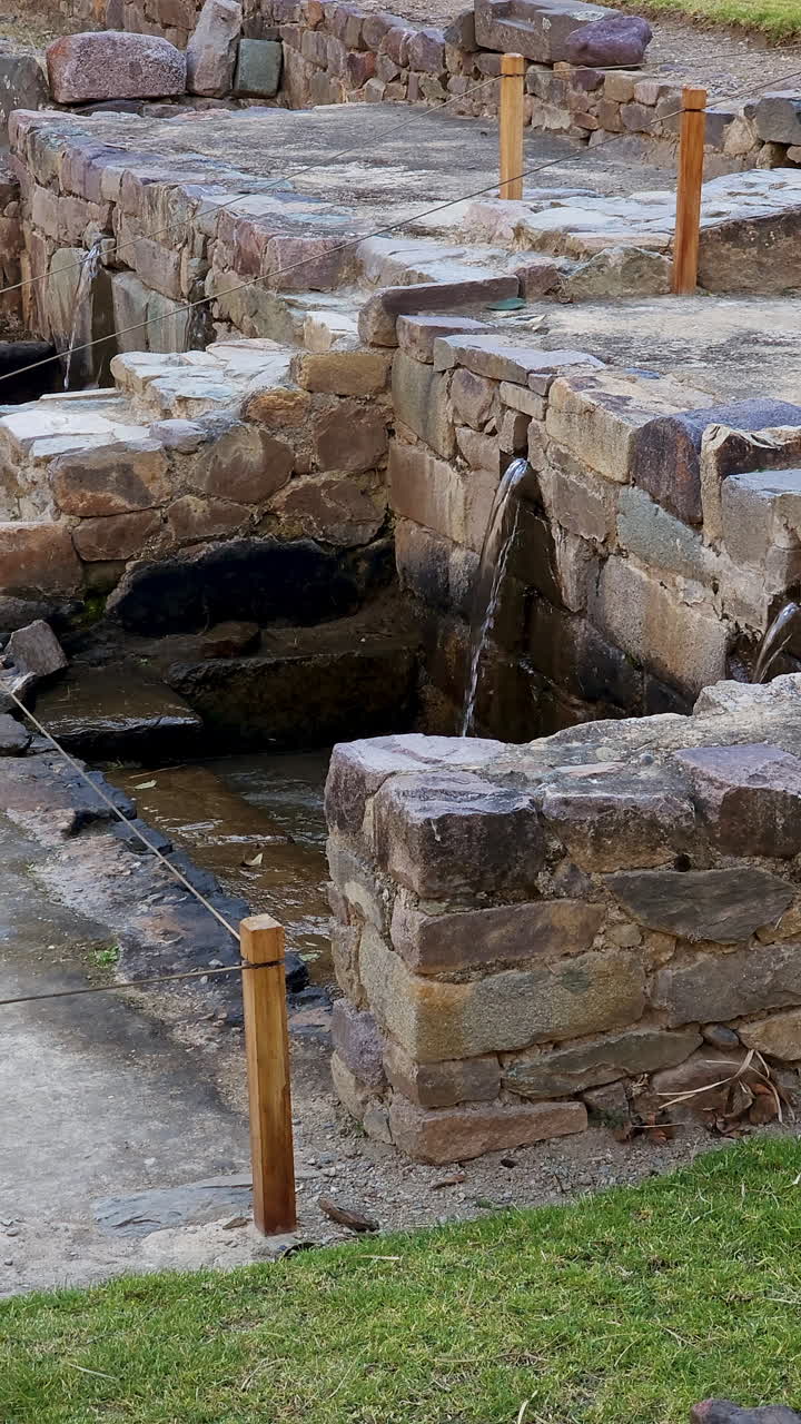 The remarkable ancient engineering of the Incas, showcasing the well-preserved aqueducts and fountains at the archaeological site of Ollantaytambo, Peru