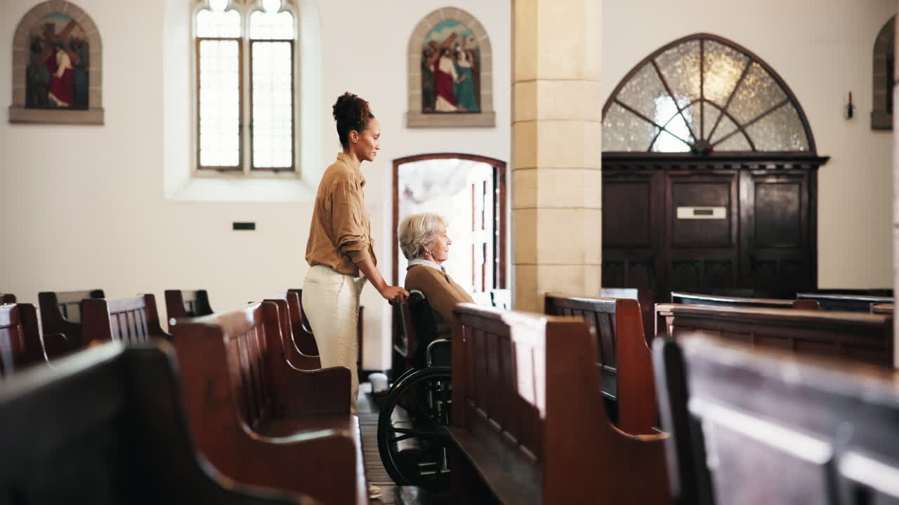 Elderly woman in wheelchair with caregiver in a church