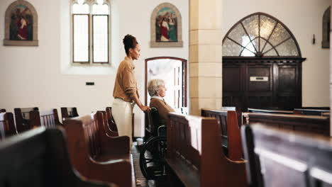 elderly woman in wheelchair with caregiver in a church