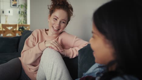 two female caucasian and mixed race women spending time at home together.