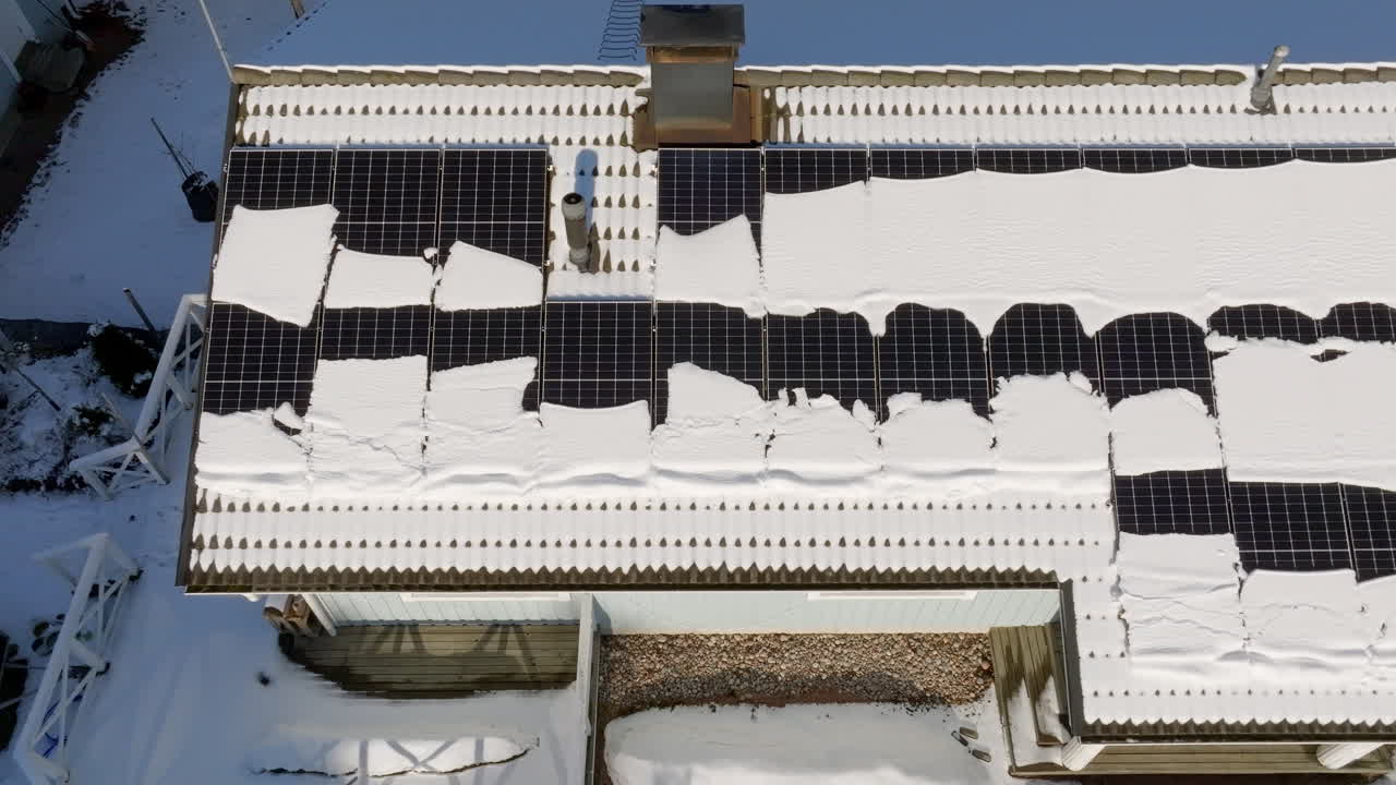 Snow Covered Solar Panels on a House Roof