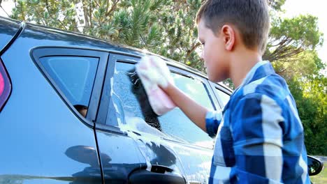 Boy-washing-a-car-4k