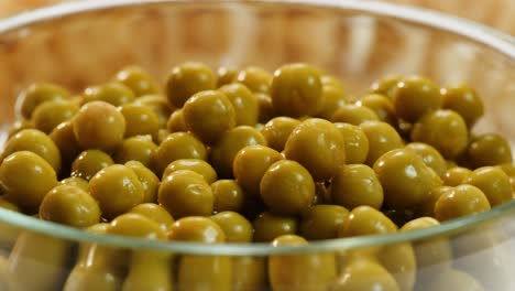 canned green peas in glass bowl