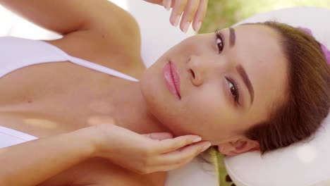 smiling young woman relaxing at an outdoor spa