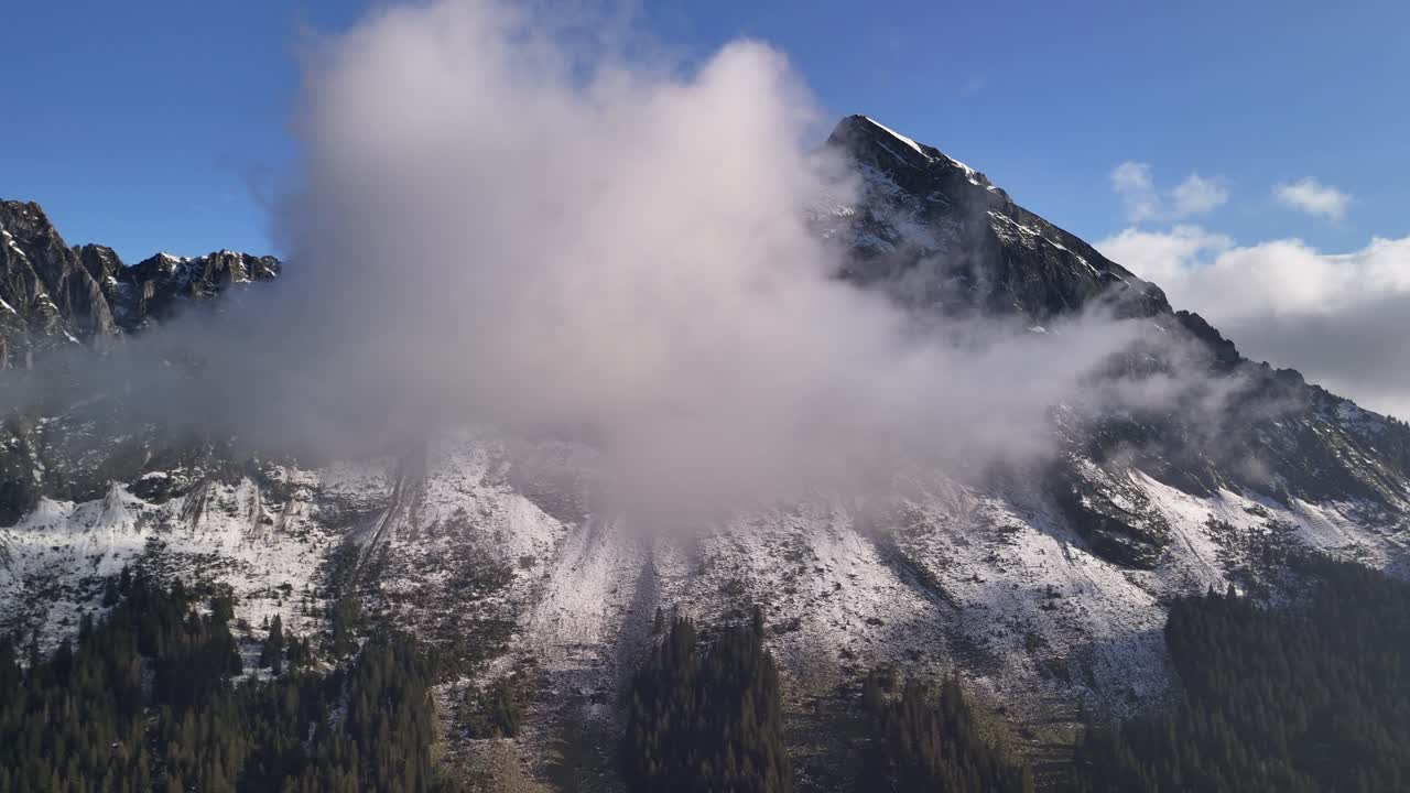 Fog over snowy mountain peak in Switzerland Fronalpstock Schwyzer Alps