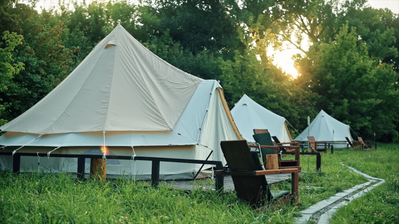 Glamping, few tents, chairs and pathway on the foreground, geenery around