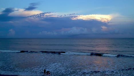 Aerial-push-over-surf-at-sunset-at-carolina-beach-nc,-north-carolina