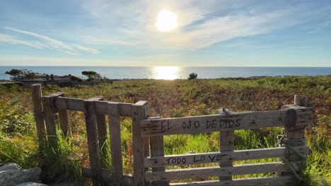 sunset over the ocean with a wooden gate