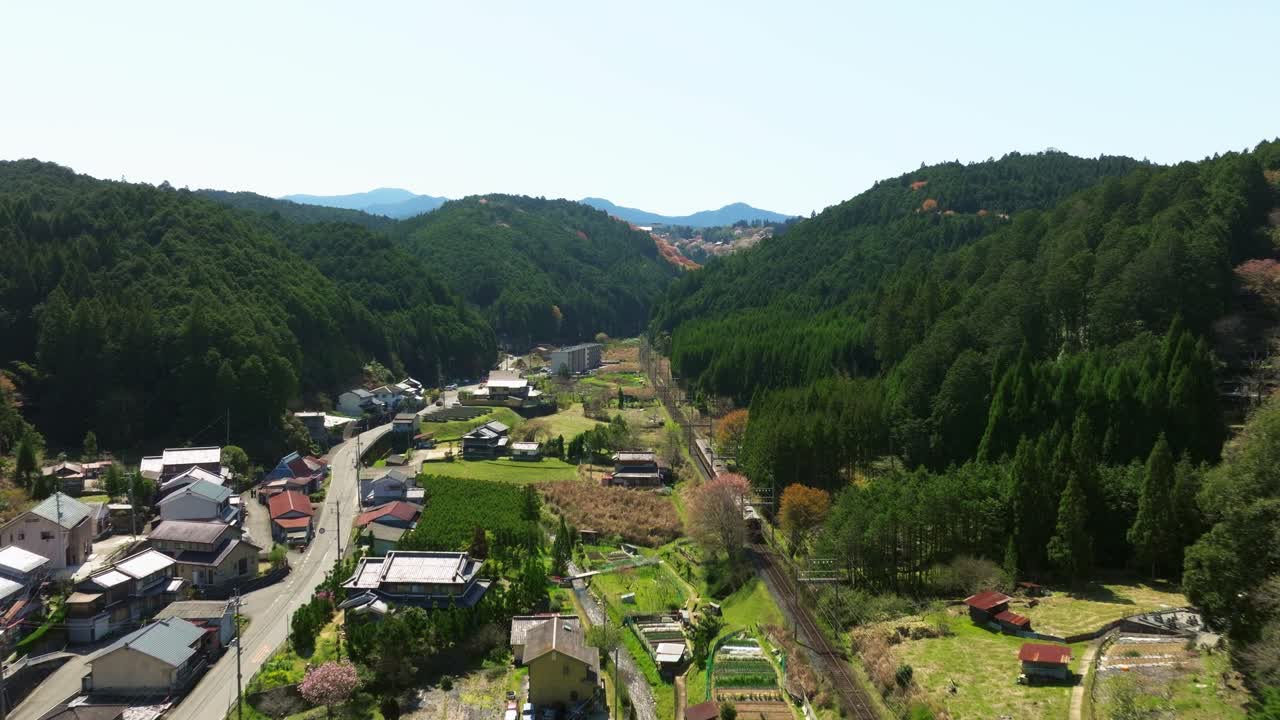 Aerial landscape of a train riding along Spring in a Japanese mountain valley village Yoshino mountain