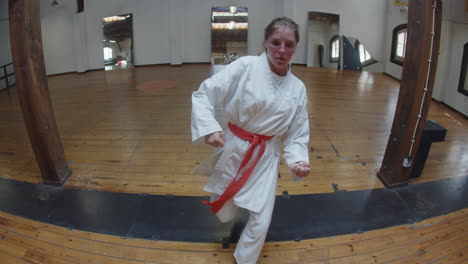 tracking shot of martial artist having karate class in gym