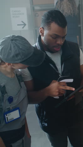 warehouse workers checking documents