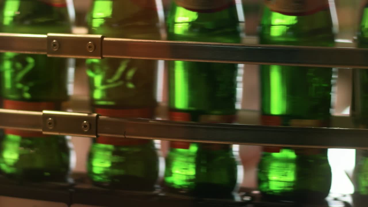 Beer production line. Brewery conveyor. Bottles moving on manufacturing line