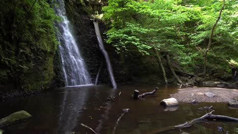 Tourist-checking-out-a-waterfall-from-the-distance