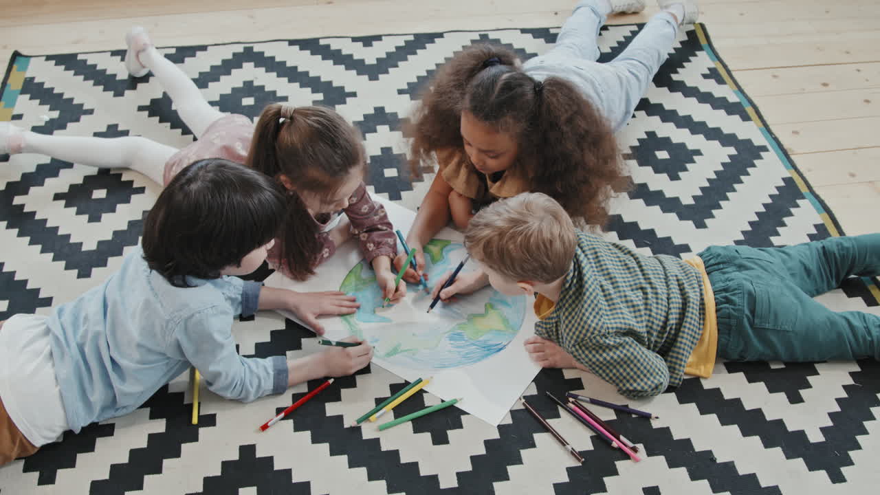 Children Lying on Rug and Coloring Picture