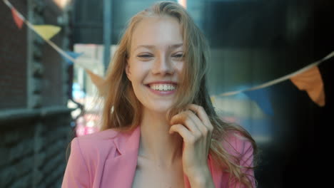 smiling young woman in pink blazer