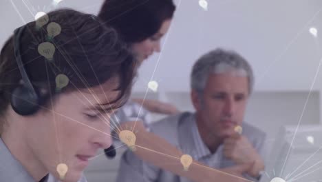 Animation-of-network-of-connection-with-icons-over-business-people-wearing-phone-headsets