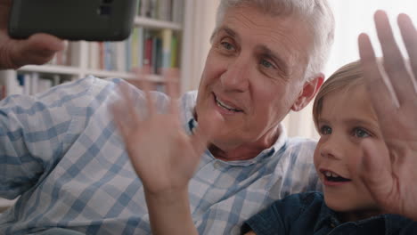 grandfather and child having video chat using smartphone little boy sharing vacation weekend with family grandpa enjoying chatting on mobile technology at home with grandson