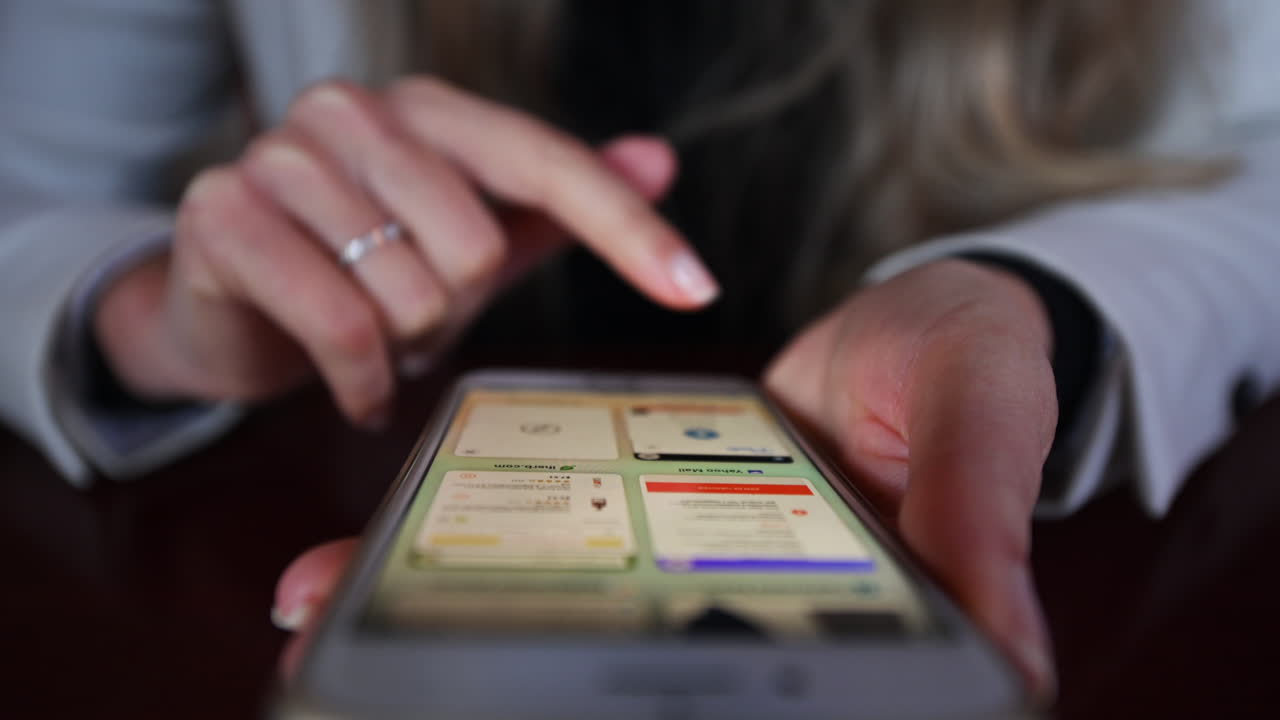CHISINAU, MOLDOVA - NOVEMBER, 2021: Woman working on mobile phone in a restaurant at lunch