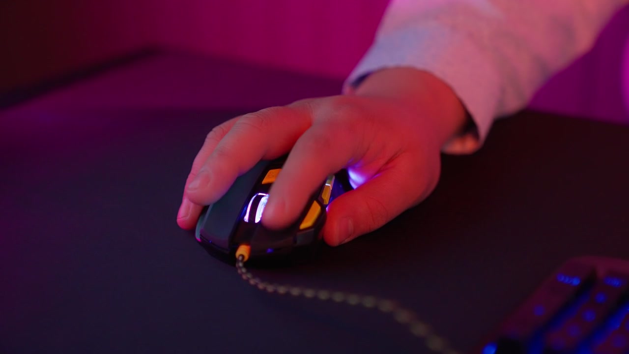 Close Up of Hand Clicking Gaming Mouse with Neon Lights
