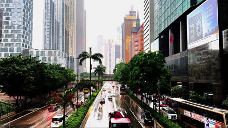 slow motion traffic on rain-soaked gloucester road, hong kong on a gloomy day