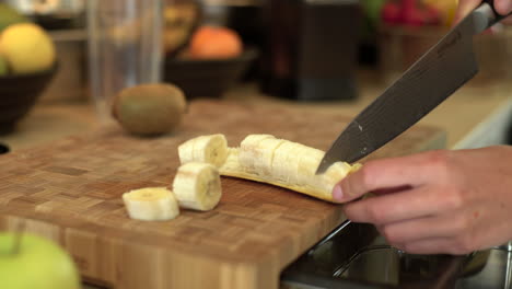 Close-Up-of-Female-Hands-Slicing-a-Banana