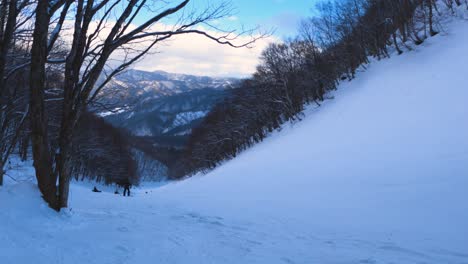 snowboarding going down hill through the mountains of hida, gifu japan
