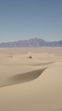 sand dunes and mountains in a desert landscape