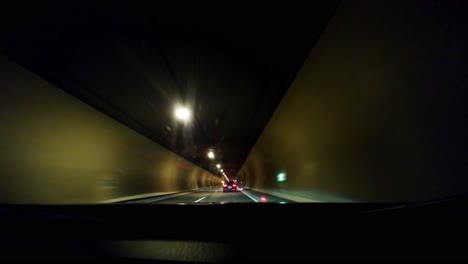 driving timelapse on a highway through a tunnel with other cars driving on a sunny day shot through the windshield