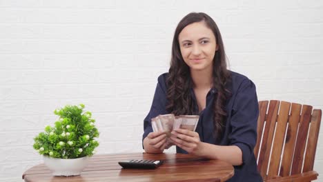 Happy-Indian-girl-counting-money