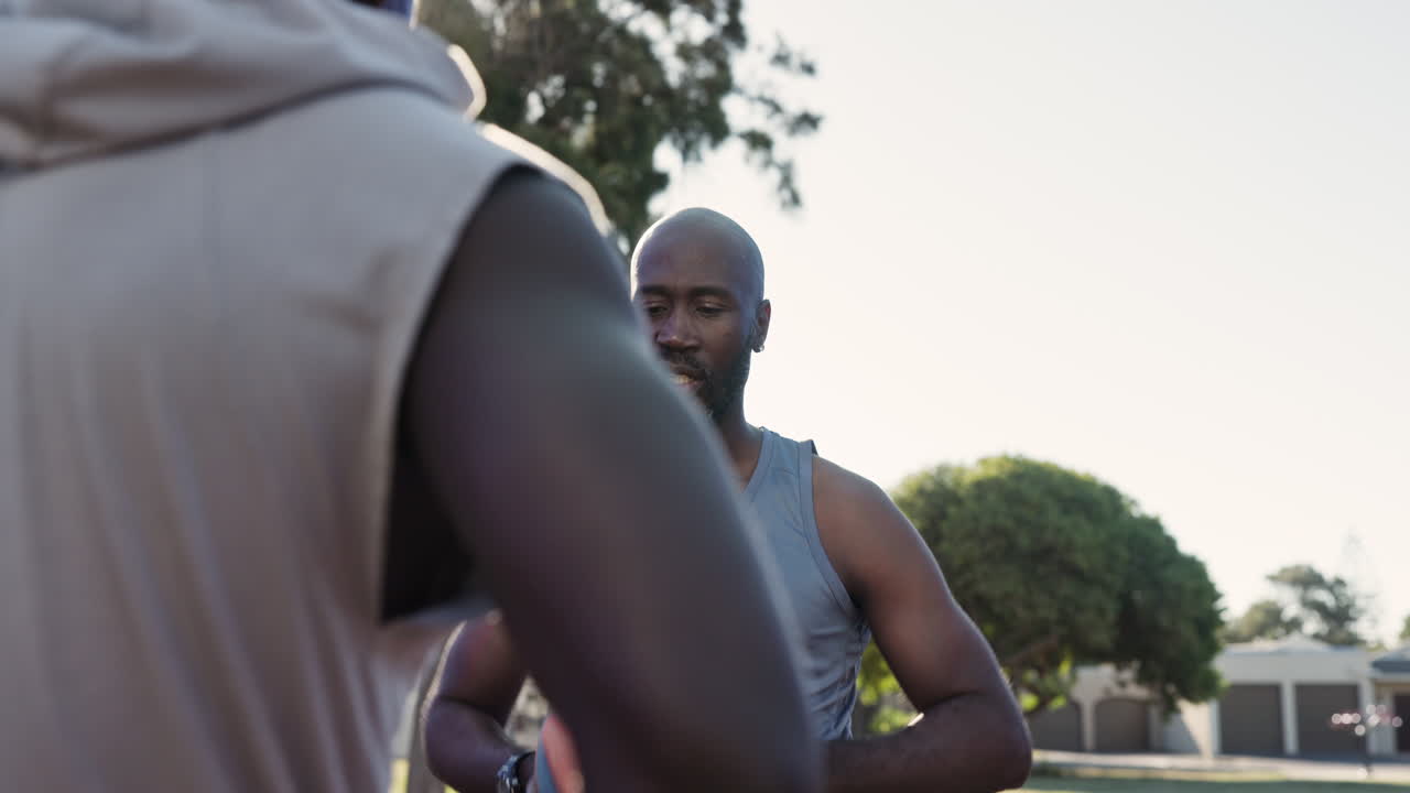 Men playing basketball on an outdoor court