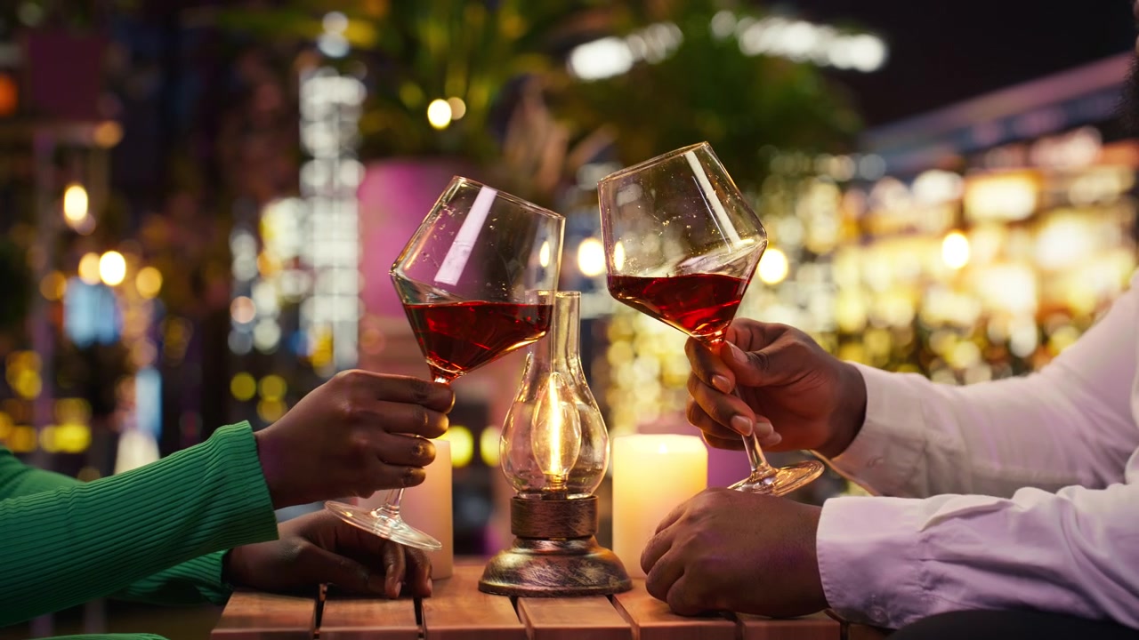 Close up of couple doing toast to celebrate anniversary during intimate date