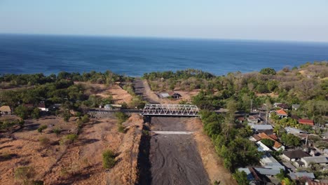 Aerial-footage-capturing-the-scenic-landscape-of-Tulamben,-Bali,-with-a-view-of-the-surrounding-coastline