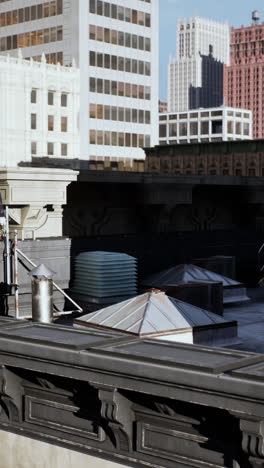 a close up view of a city's rooftop with tall buildings in the background