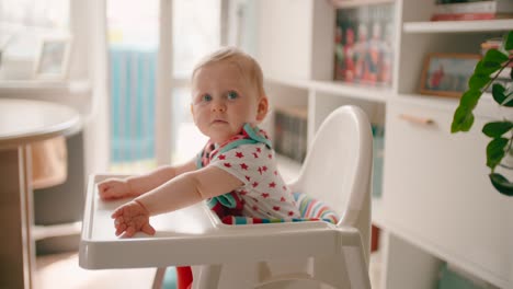 shy baby girl on high chair