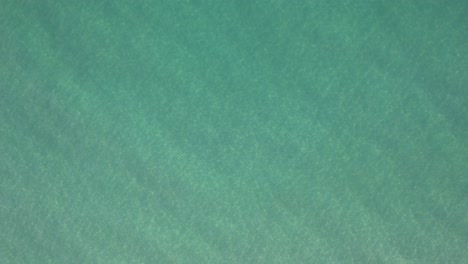 Aerial-view-of-clear-emerald-waters-of-the-Gulf-of-Mexico-of-the-sore-of-Pensacola-beach-Florida