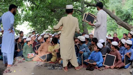 giving blackboards to boys in a remote school