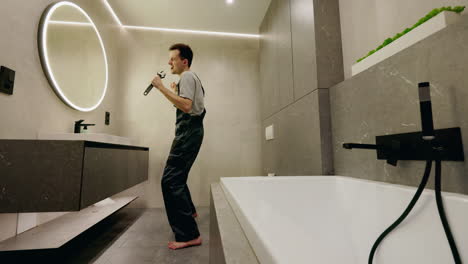 man singing in modern bathroom