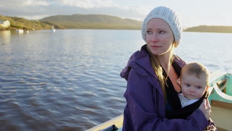 mother with her baby travelling on motor boat 4k